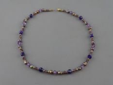 A NINE CARAT GOLD AMETHYST, GARNET & BLACK PEARL NECKLACE, 41 cms long
