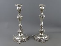 A FINE PAIR OF CIRCULAR SILVER CANDLESTICKS having scrolled bases with shaped and scrolled