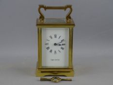 A MAPPIN & WEBB BRASS CASED CARRIAGE CLOCK with key, the dial set with Roman numerals, 15 cms