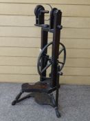 A GEORGE III PERIOD MAHOGANY SPINNING WHEEL with unusual lead rimmed drive wheel, 85 cms high