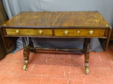 A REGENCY MAHOGANY TWIN FLAP SOFA TABLE having twin frieze drawers, opening to both sides, on turned