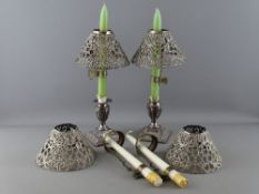 A PAIR OF SILVER STUBB CANDLESTICKS and four white metal reticulated candle shades, the classical