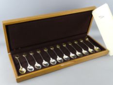 A CASED SET OF TWELVE RSPB COLLECTOR'S SILVER SPOONS, hallmarked London 1975, each set with gold