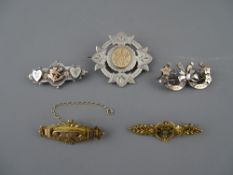 FIVE VICTORIAN NINE CARAT GOLD SILVER & YELLOW METAL MOUNTED BROOCHES