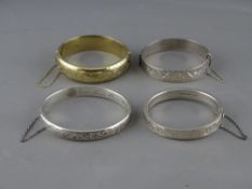FOUR BRIGHT CUT DECORATED SILVER BANGLES, 94.5 grms gross