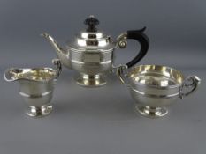 A THREE PIECE BACHELOR'S SILVER TEA SERVICE, pedestal form with scroll handles, Chester 1901, 12.4