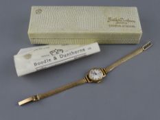A NINE CARAT GOLD BOODLE & DUNTHORNE LADY'S WRISTWATCH with bracelet strap, 14.2 grms gross with