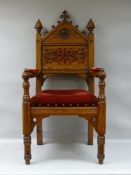 A GOTHIC STYLE PITCH PINE ECCLESIASTICAL ARMCHAIR, formerly from a church in Abergele and reportedly
