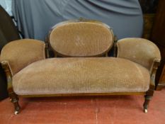 A CARVED WALNUT CAMEO BACK SETTEE having swept arm ends on turned and reeded front supports and