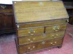 A GEORGIAN OAK FALL FRONT BUREAU with interior sliding well and mixed drawer and pigeonhole