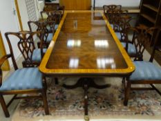 A REPRODUCTION CROSSBANDED MAHOGANY TWIN PEDESTAL DINING TABLE and a set of eight (six plus two)