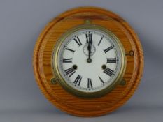 A BRASS SHIP'S BULKHEAD CLOCK, painted 7 ins dial set with Roman numerals, subsidiary seconds dial