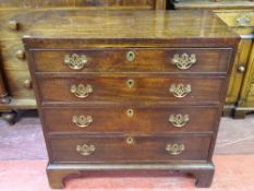 A GEORGIAN MAHOGANY CHEST OF FOUR DRAWERS, oak lined with cockbeaded edges and replacement pierced