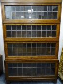 A GLOBE WERNICKE OAK STACKING BOOKCASE with leaded glass lift-up doors, 132 cms high, 85.5 cms wide,