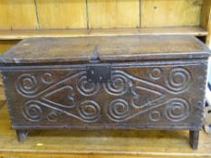 AN ANTIQUE OAK SIX PLANK CHEST with carved front detail, 42 cms high, 80 cms wide, 32 cms deep,