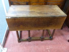 A CIRCA 1830 PERIOD OAK TWIN FLAP GATE LEG DINING TABLE on turned and block supports, 74 cms high,