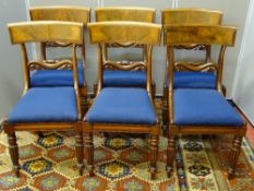 A SET OF SIX REGENCY MAHOGANY DINING CHAIRS with curved back and carved central rail, upholstered