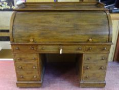 A VICTORIAN TWIN PEDESTAL CYLINDER FALL WRITING DESK with slide-out interior, gilt tooled leather