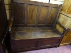 A 19th CENTURY OAK BOX SEAT HALL BENCH, peg joined construction with panelled back and swept arms on