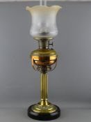 A VICTORIAN BRASS OIL LAMP with Aladdin model 12 burner on a column stem with circular pot base