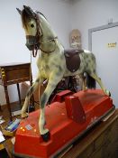 Vintage style dapple grey child's ride-on horse on a motorized wheeled base by Haddon Rockers,