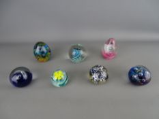 Seven vintage glass paperweights