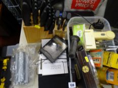 Tub containing various garage items, two wooden blocks with a selection of household knives,