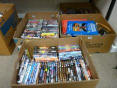 Four boxes of assorted DVDs