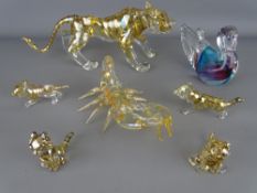 Collection of glass figurines including a tiger and four cubs, a duck and a scorpion