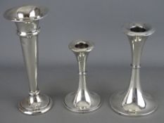Two candlesticks and a vase, all trumpet shaped in hallmarked silver