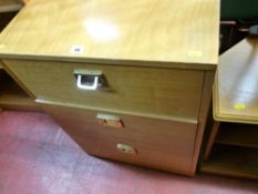 Light wood three drawer filing cabinet with brass handles