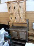 Dark stained bamboo storage unit with central cupboard doors and a similar lighter bamboo shelving