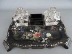 Victorian papier mache desk stand having twin glass ink bottles and mother of pearl inlay