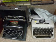 Vintage Olympia Progress portable typewriter in carry case and a slightly more modern Olympia