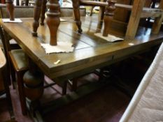 Oak draw leaf dining table with two chairs having upholstered seats and backs