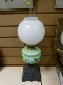 Iron based oil lamp with green milk glass shade