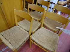 Set of six stylish light wood wicker seated dining chairs