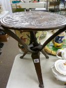 African carved hardwood folding table having animal detail to the top