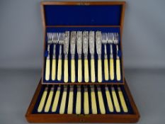 Mahogany cased set of twelve fish knives and forks all having chased decoration