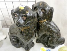 Pair of black and gilt decorated Staffs terracotta dogs with inset glass eyes