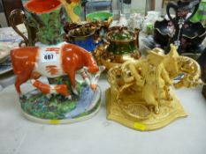 Eichwald ochre and gold colour pipe rack and striker in the form of a man with a horse and a