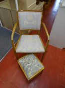 Light wood floral upholstered armchair with similar stool