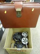 Vintage leather briefcase and a boxed quantity of film reels
