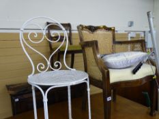 Vintage Bergere armchair and a white wrought iron garden chair