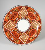 A RARE SWANSEA POTTERY PLATE enamelled with geometric design to an iron red ground impressed mark