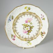 A SWANSEA PORCELAIN DESSERT PLATE with lobed rim and having a moulded border with C-scrolls,