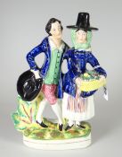 A STAFFORDSHIRE POTTERY FIGURE OF JENNY JONES & NED MORGAN modelled with Jenny in traditional