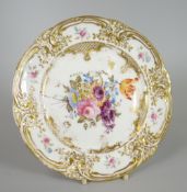 A NANTGARW PORCELAIN PLATE DECORATED WITH CENTRED FLORAL SPRAY the border gilded and moulded with
