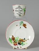 A LLANELLY POTTERY CUP & SAUCER 'PRESENTED TO HANNAH LEWIS FROM LLANELLY 1892' decorated with