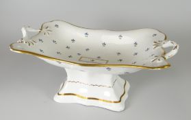 A SWANSEA PORCELAIN TWIG-HANDLED CENTRE DISH raised over a shaped rectangular pedestal base,